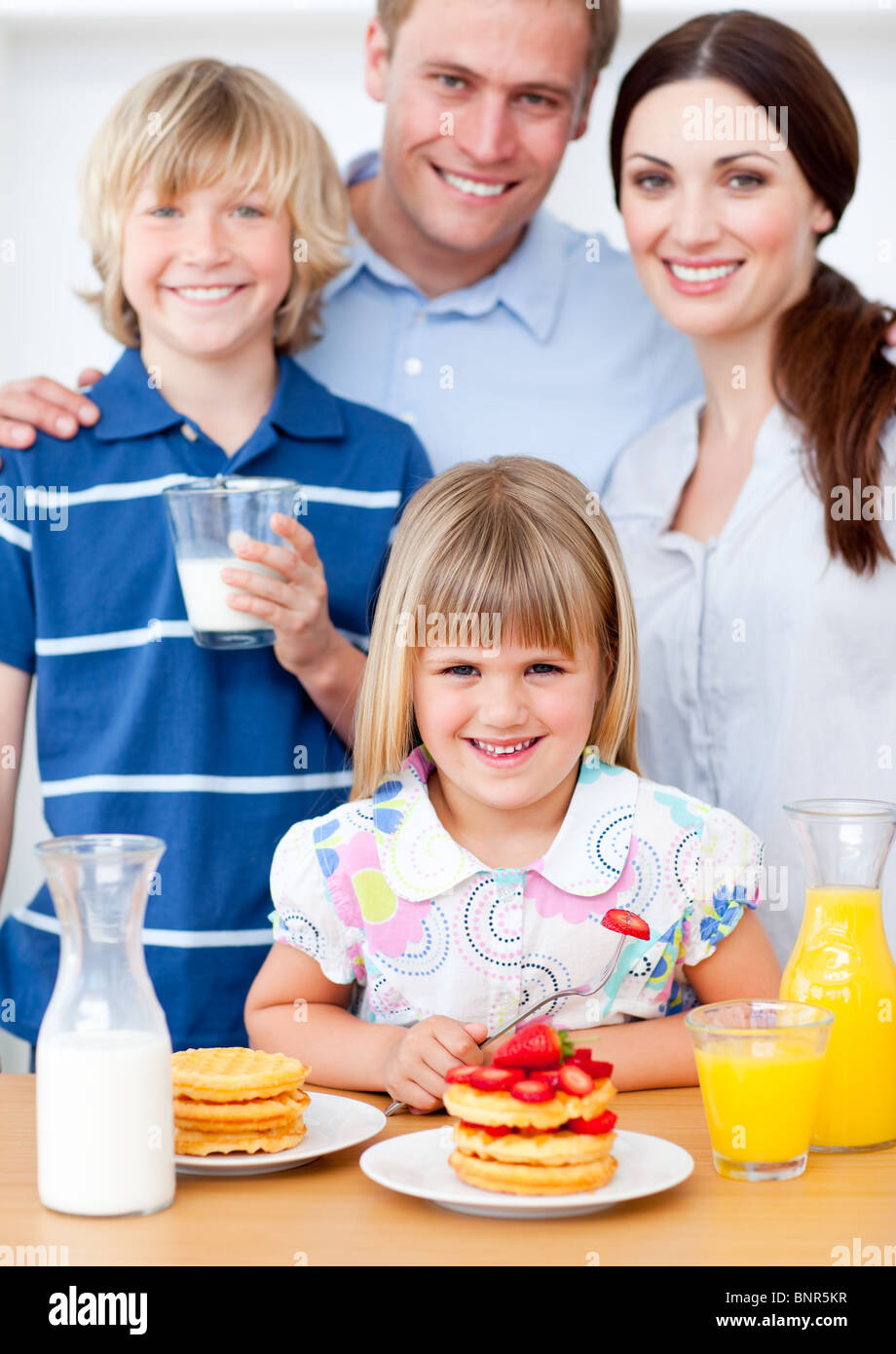 Joyful family eating breakfast in the kitchen Stock Photo