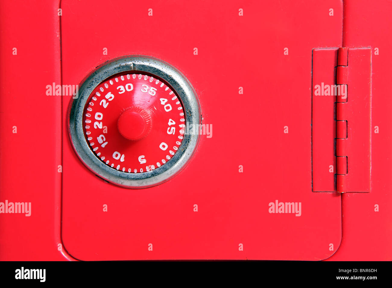 Combination lock on a toy piggy bank safe. Stock Photo
