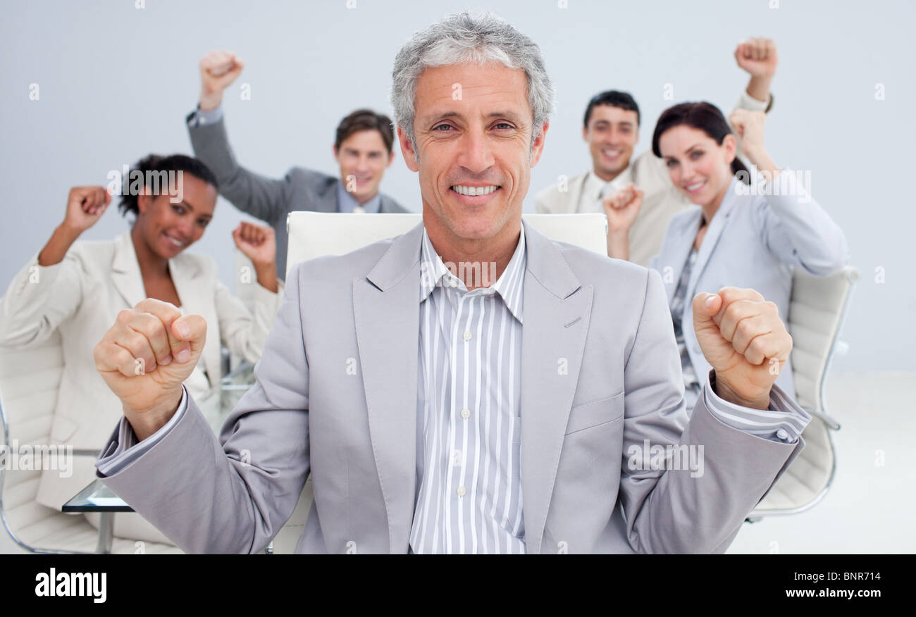 Happy businessman celebrating a sucess with his team Stock Photo - Alamy
