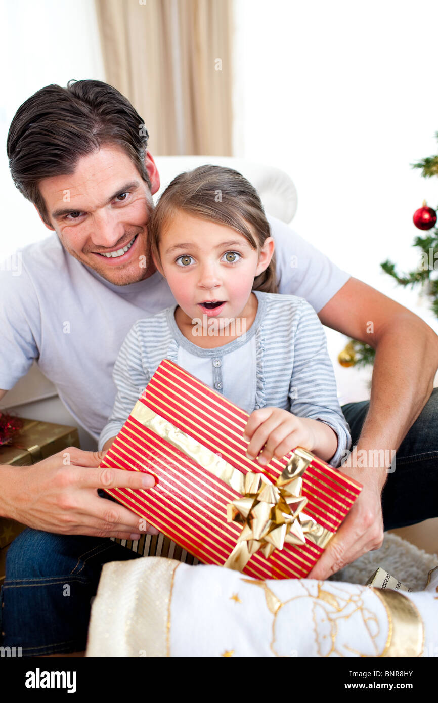 Portrait of a surprised little girl holding a Christmas present Stock ...
