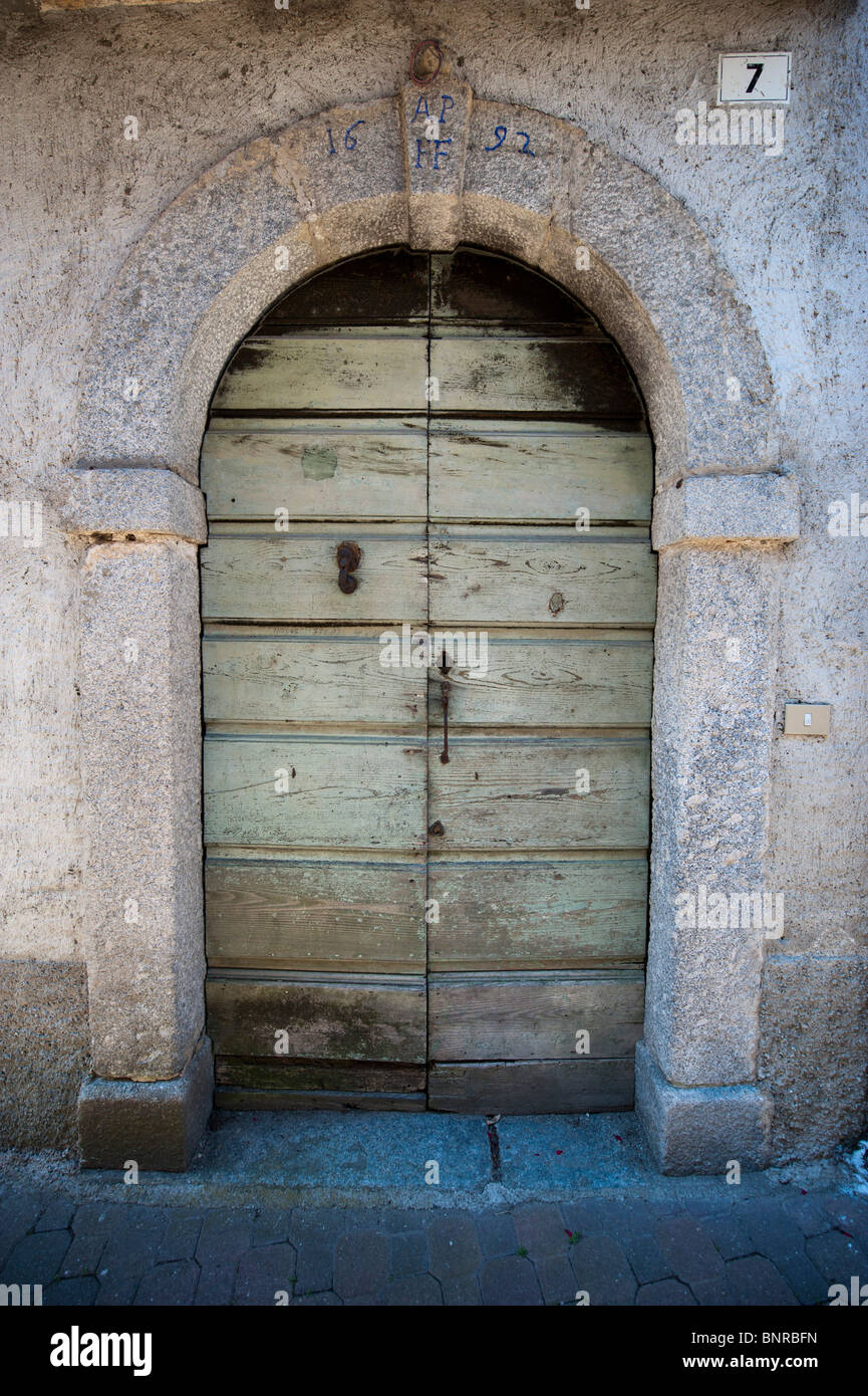 Ancient wooden door in period house in Magreglio, Italy Stock Photo