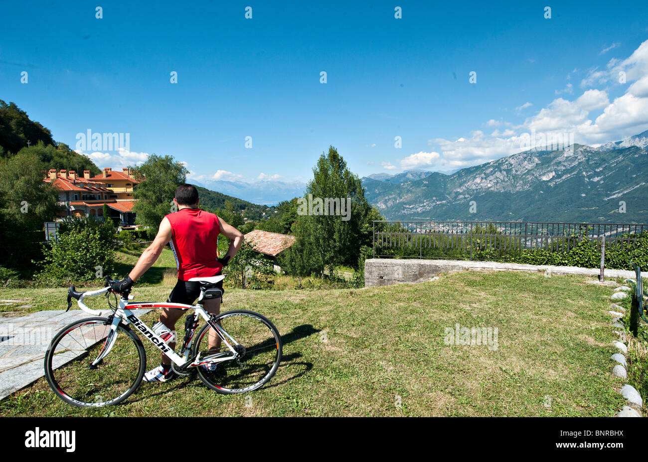 A cyclis admires the view from the Passo del Ghisallo Magreglio Lombardy Italy Stock Photo