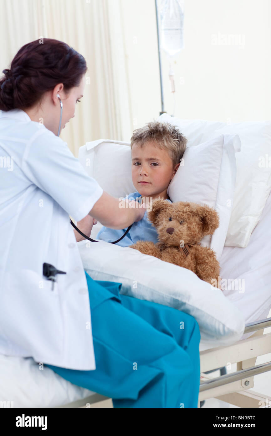 Female doctor listening to a child chest with stethoscope Stock Photo ...