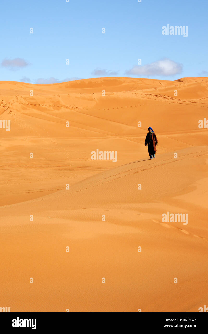 Bedouin on a dune in Erg Chebbi, Merzouga, Morocco Stock Photo