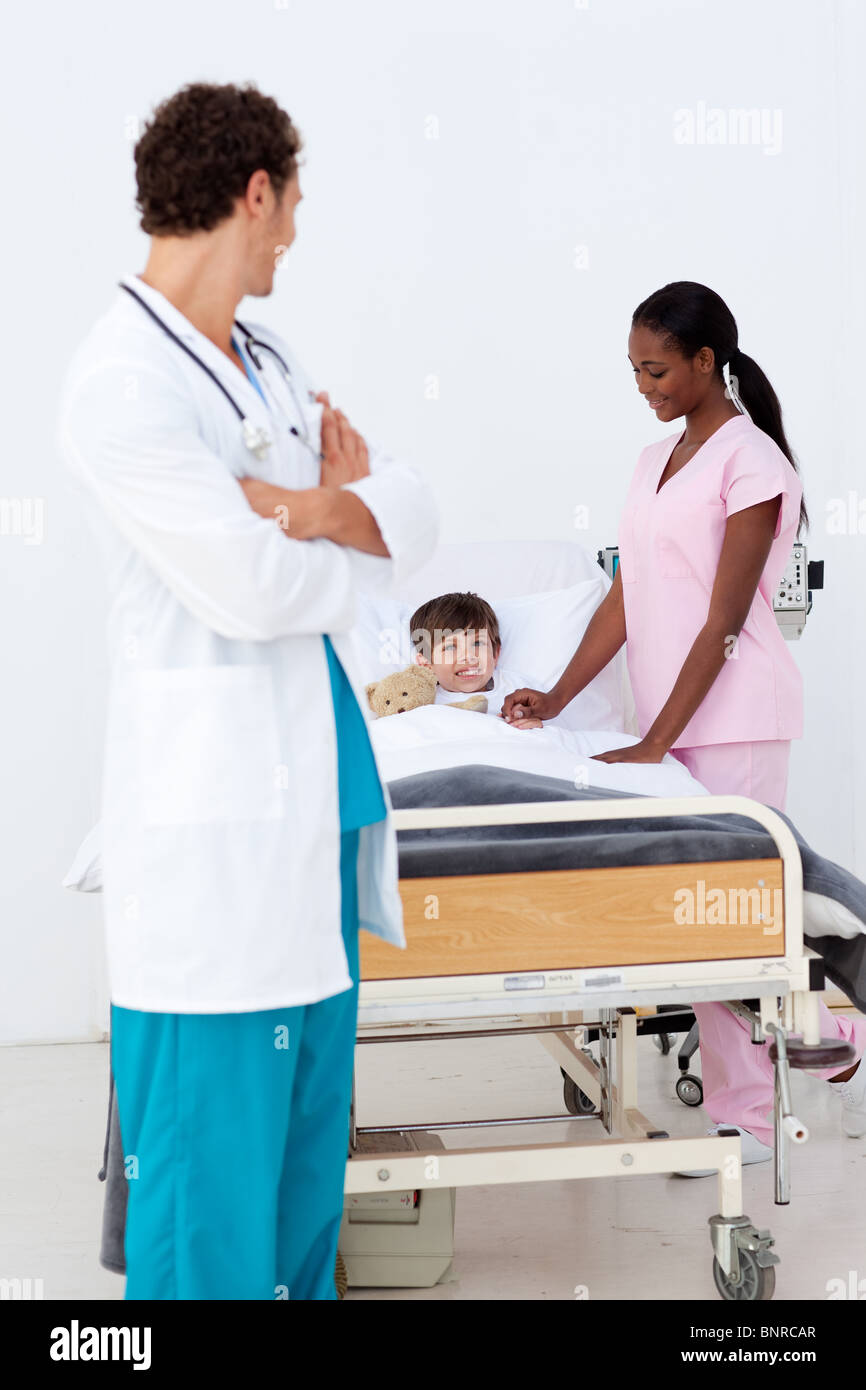 Pediatrician and nurse attending to a child in the hospital Stock Photo
