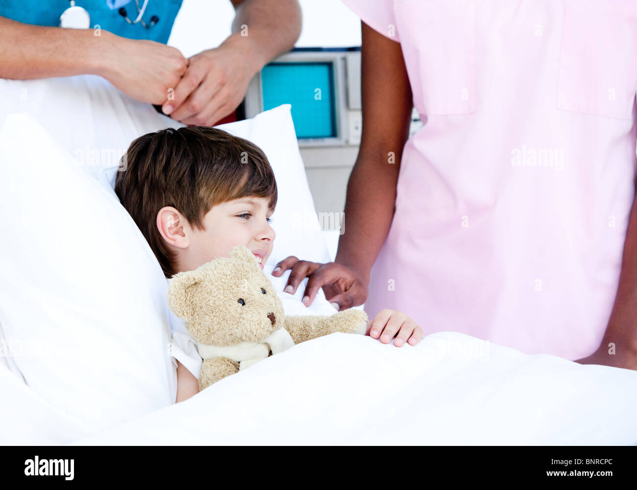 Adorable little boy hugging a teddy bear lying Stock Photo - Alamy