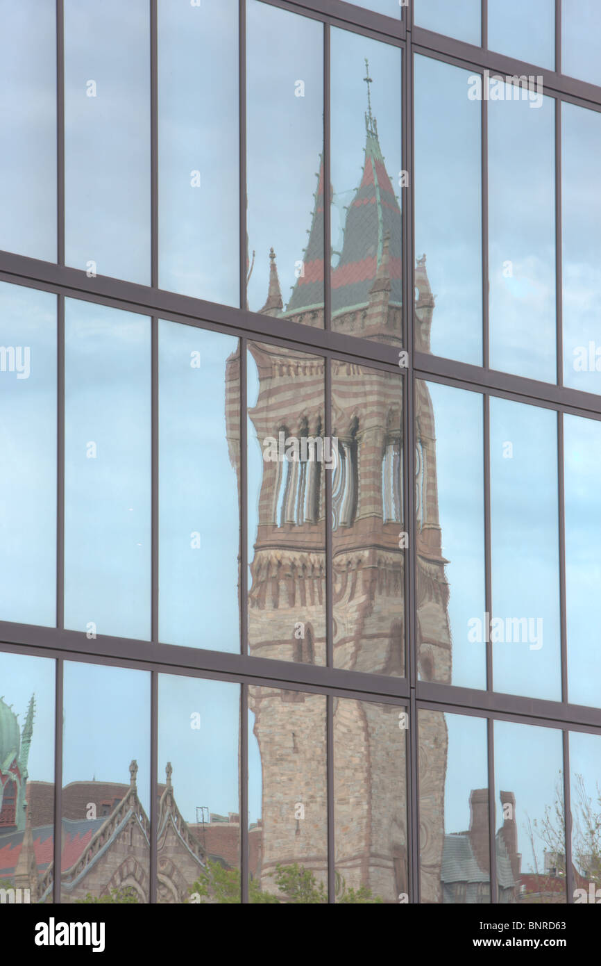 Boston's New Old South Church, located in Copley Square, reflected in the windows of the John Hancock building in Boston, Massachusetts. Stock Photo