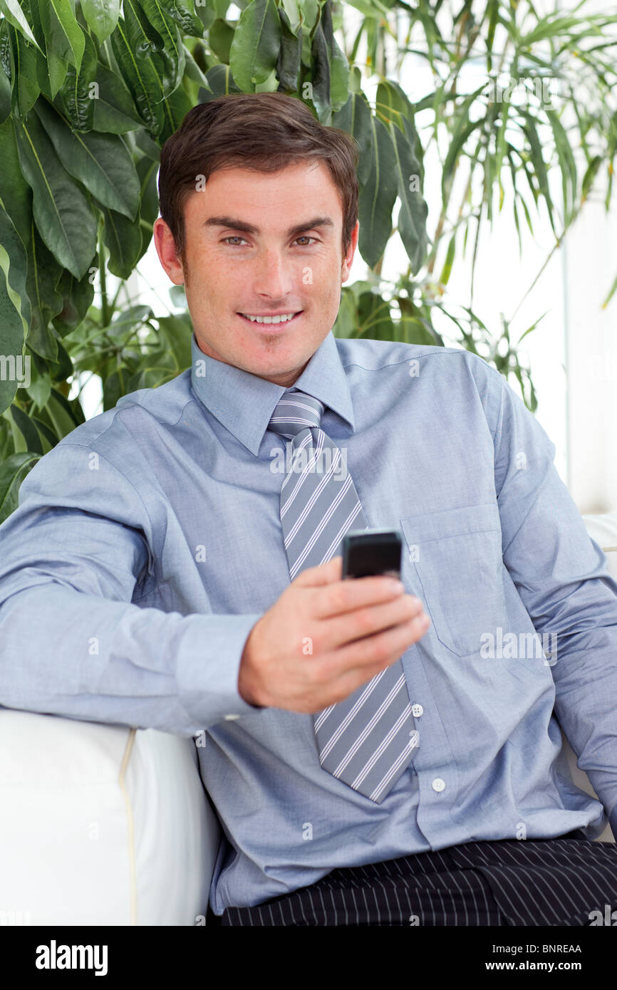 Attractive businessman writing a message Stock Photo - Alamy