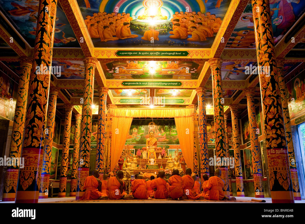 Novice monks attending evening prayers in a Cambodian wat - Kandal Province, Cambodia Stock Photo