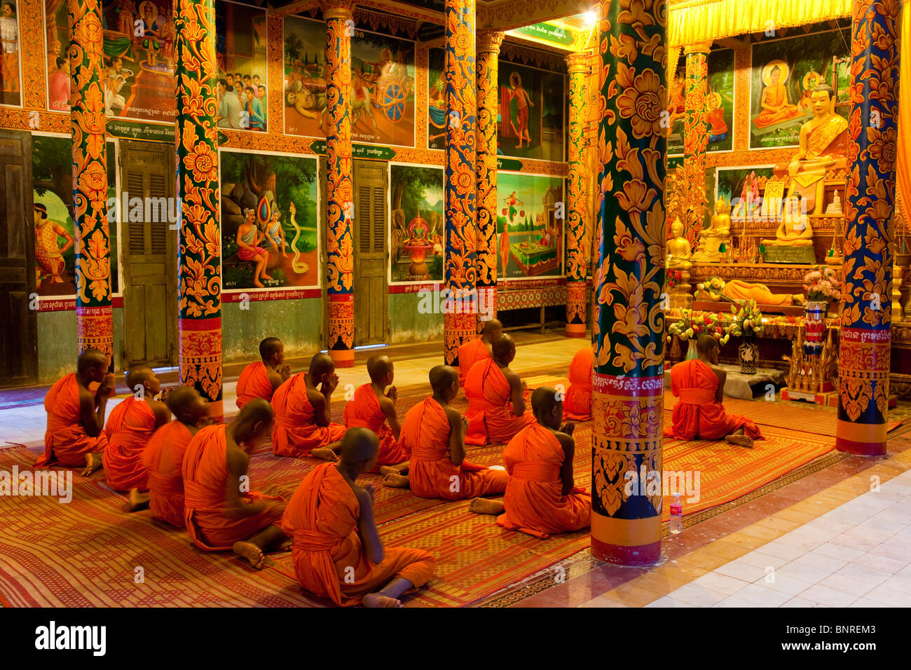 Novice monks chanting evening prayers in a Cambodian pagoda - Kandal Province, Cambodia Stock Photo