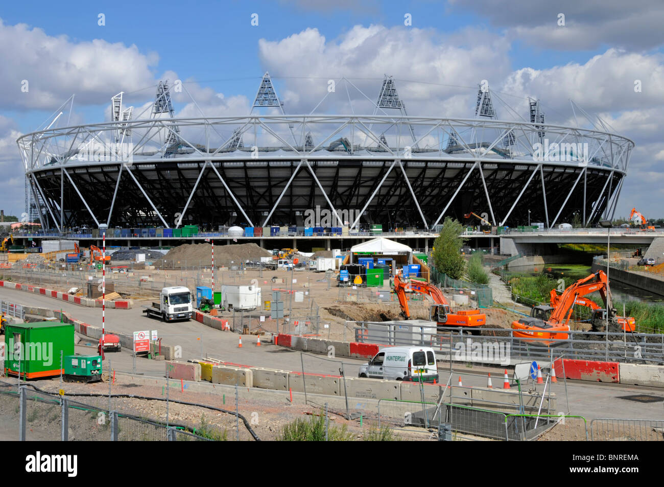 2012 Olympic stadium structure complete on building construction site paving & road work in progress at Stratford City Newham East London England UK Stock Photo