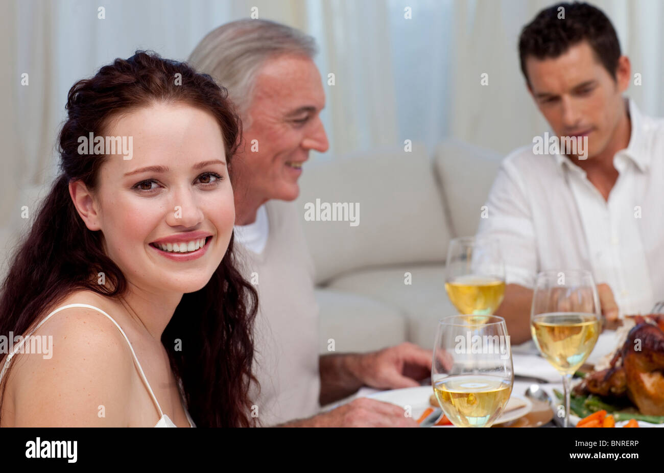 Woman celebrating Christmas dinner with her family Stock Photo