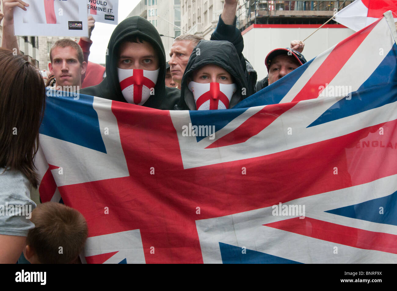 Two people in EDL St George masks and Union Jack at start of English ...