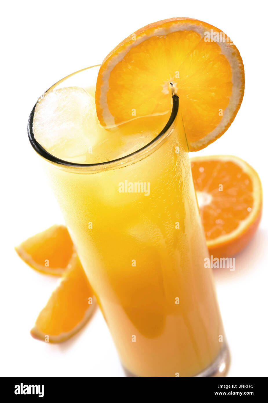 Glass of icy orange juice with orange slice (isolated against white) Stock Photo