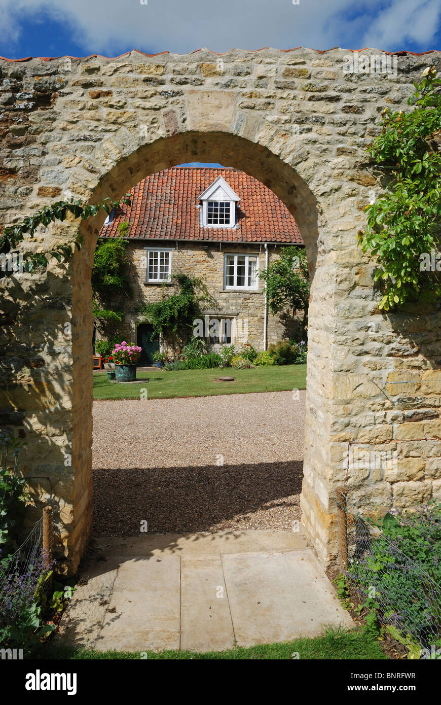 An archway leading to cottages to the rear of Fulbeck Hall, Lincolnshire, England. Stock Photo