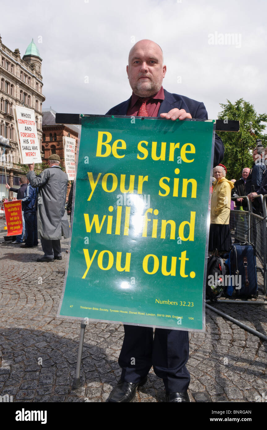 Man holds a banner "Be sure your sin will find you out" (Numbers 32:23) Stock Photo