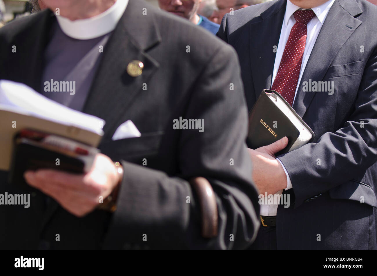 Protestant ministers holding bibles Stock Photo