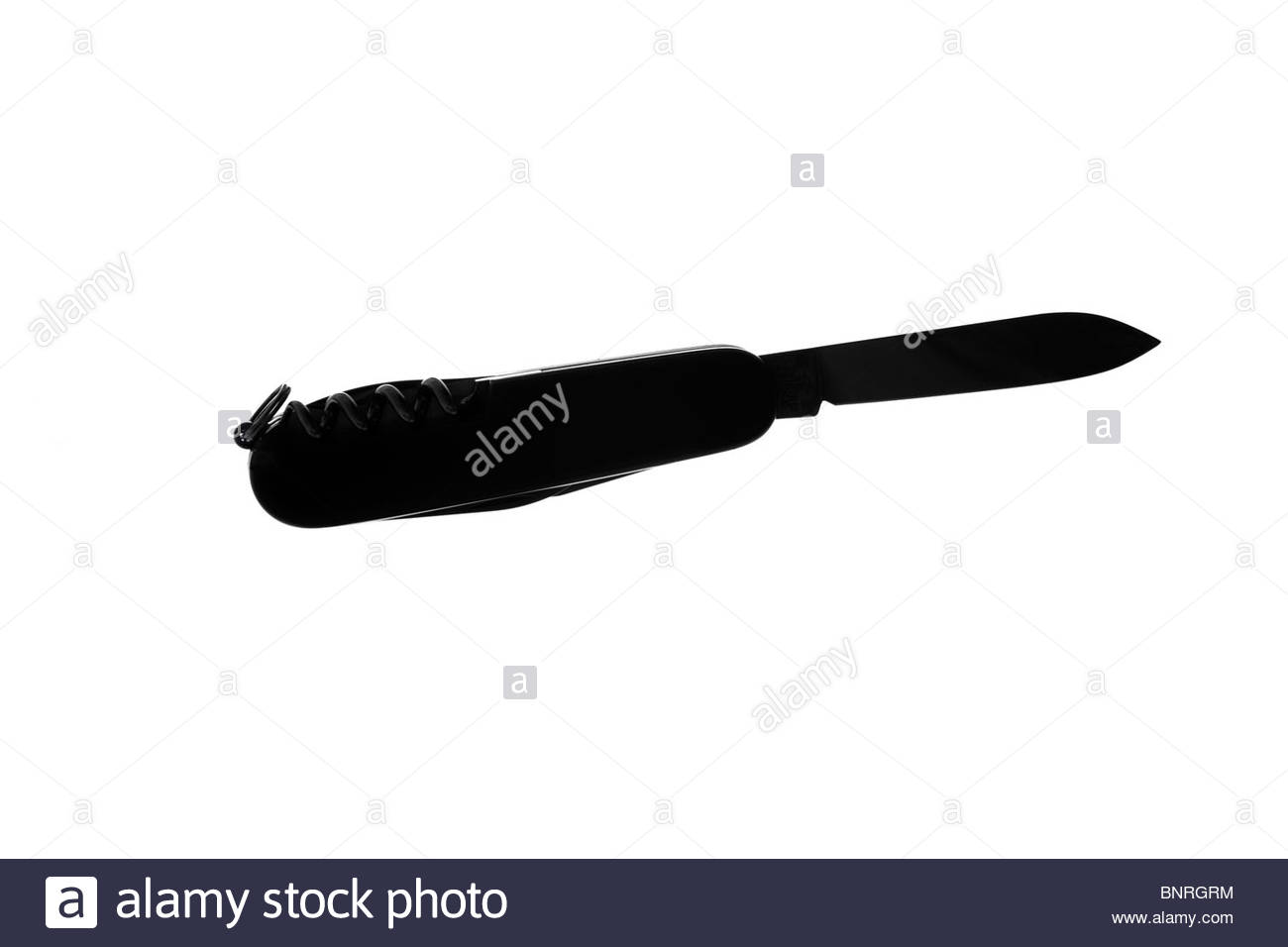 Silhouetted penknife Stock Photo