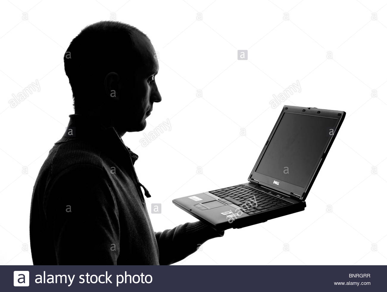 Silhouetted Man holding laptop Stock Photo