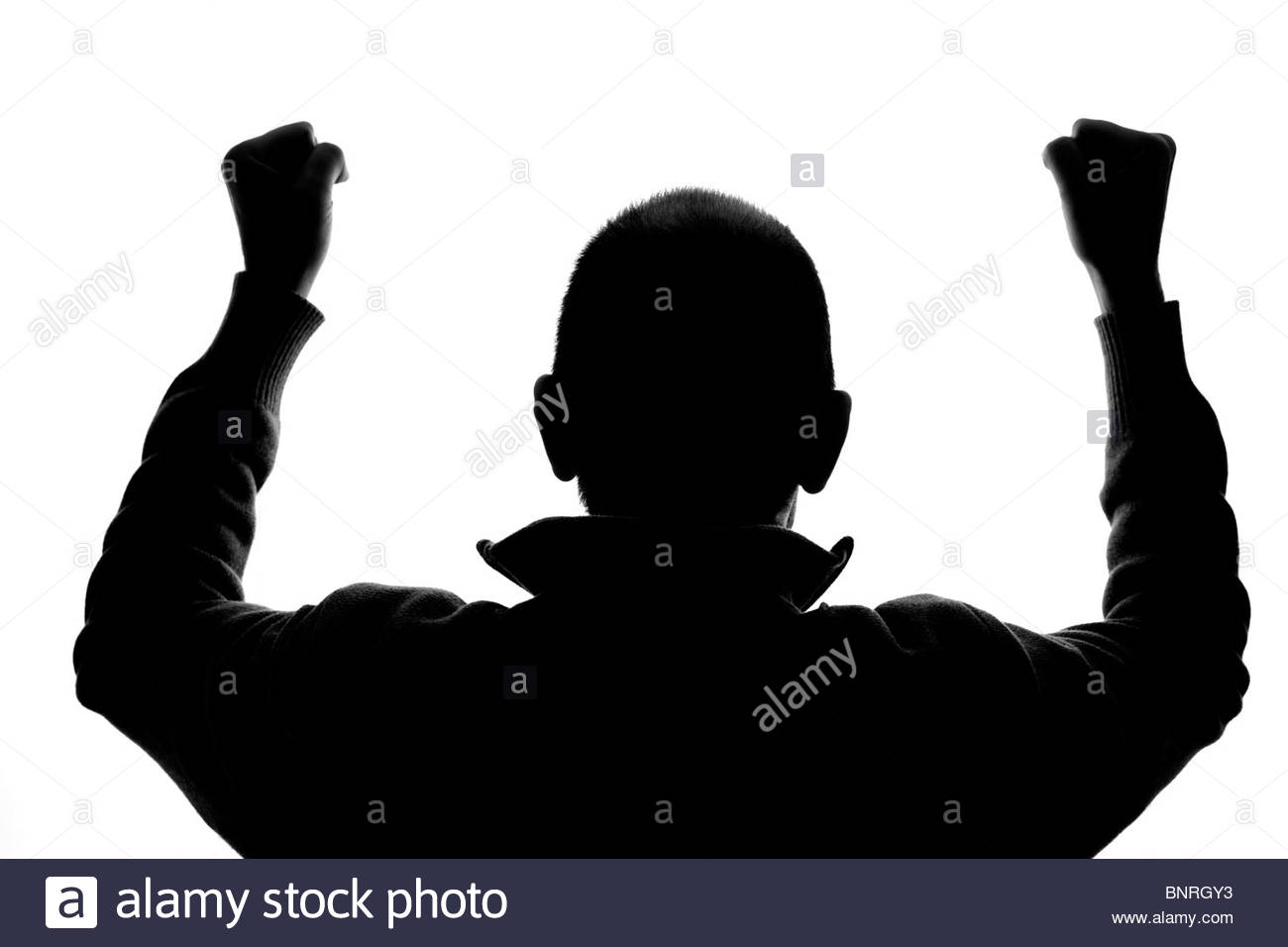 Silhouetted man cheering Stock Photo