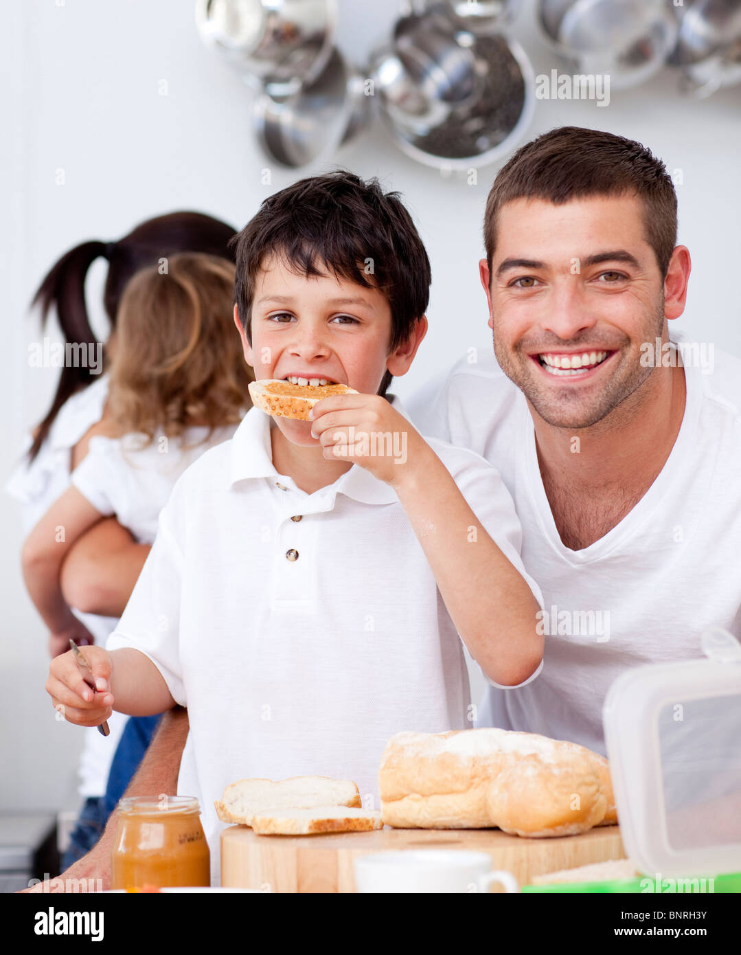 Father and son eating a toast in breakfast time Stock Photo Alamy