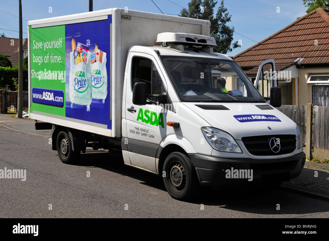 Asda supermarket food shopping van driver making a delivery Stock Photo