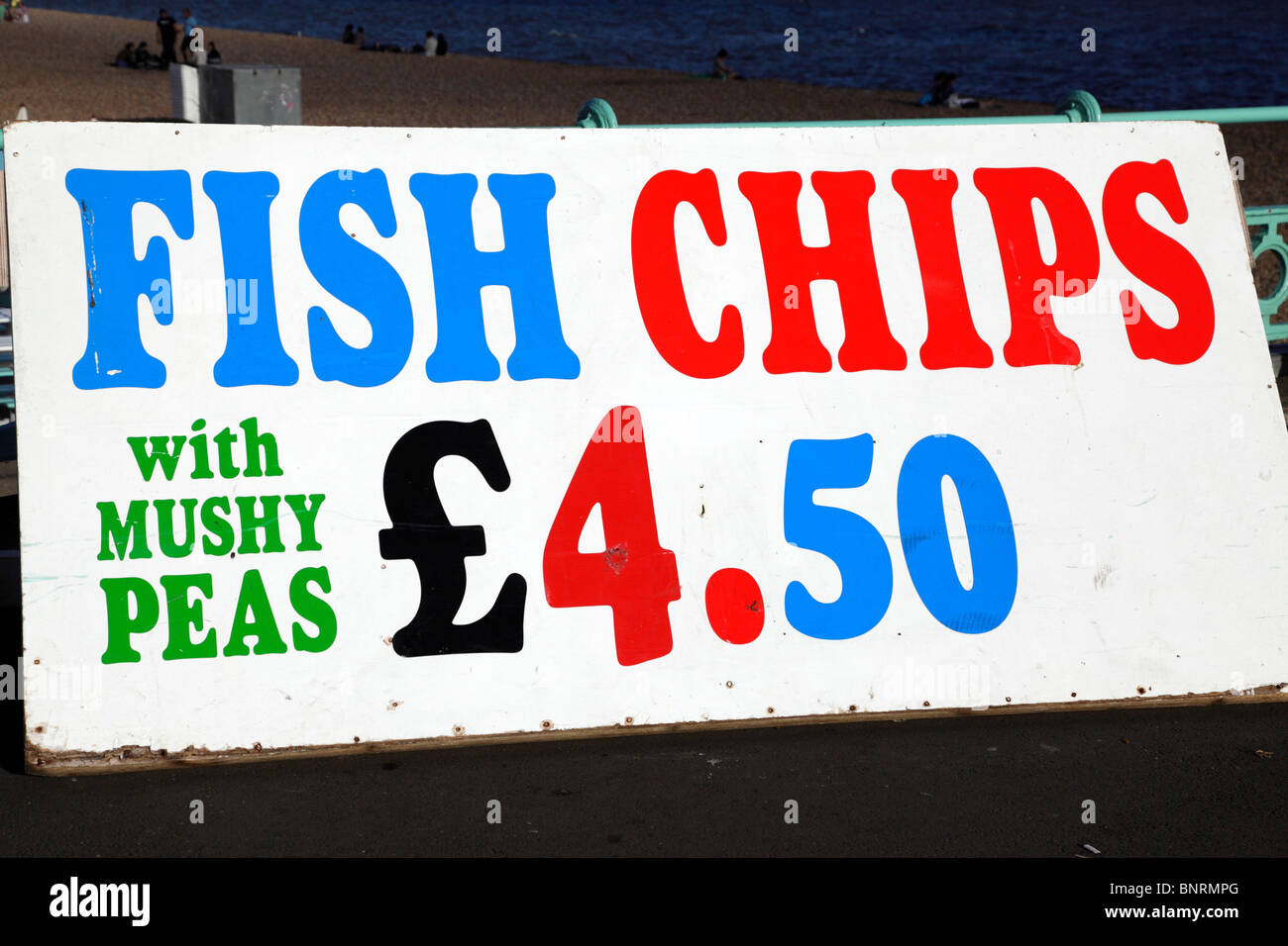 Fish chips and mushy peas sign on the seafront in Brighton England UK Stock Photo