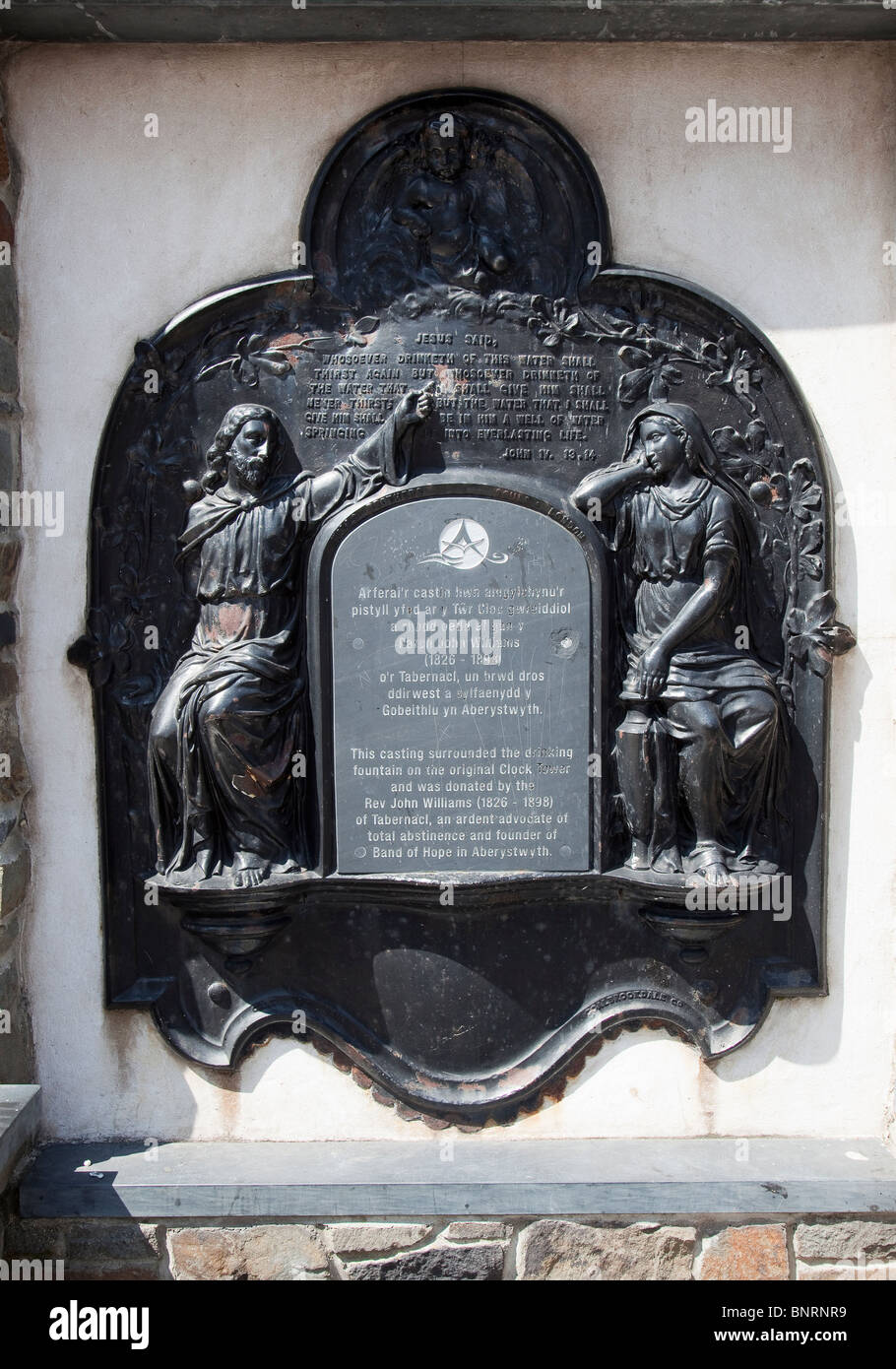 Plaque on public water fountain in Welsh and English Aberystwyth Wales UK Stock Photo