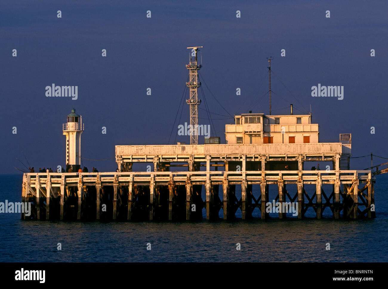 People fishing for food off the pier in the city of Ostend West Flanders Province Belgium Europe Stock Photo