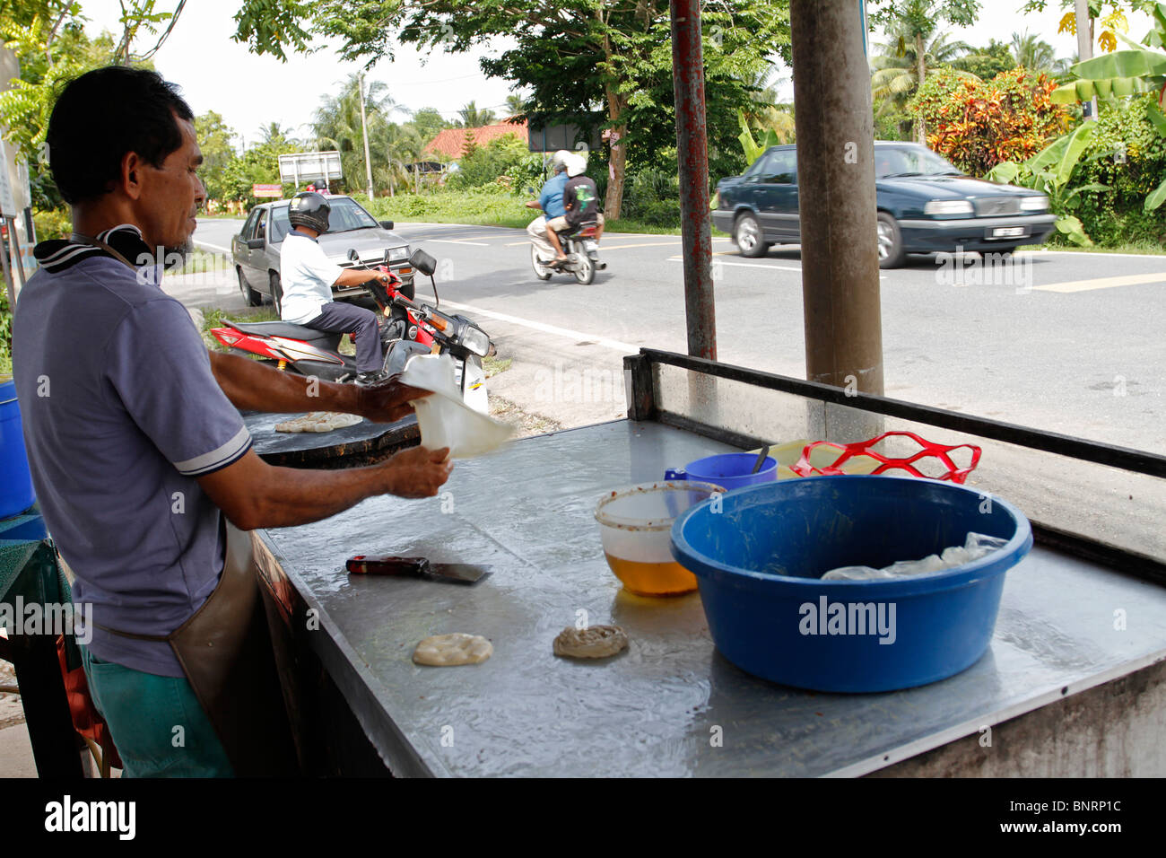 Making roti canai in Perlis, Malaysia. Roti canai is a popular food for breakfast in Malaysia. Stock Photo
