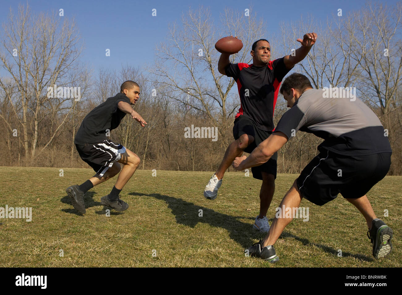 A quarterback is getting a pass off before he is sacked during a game
