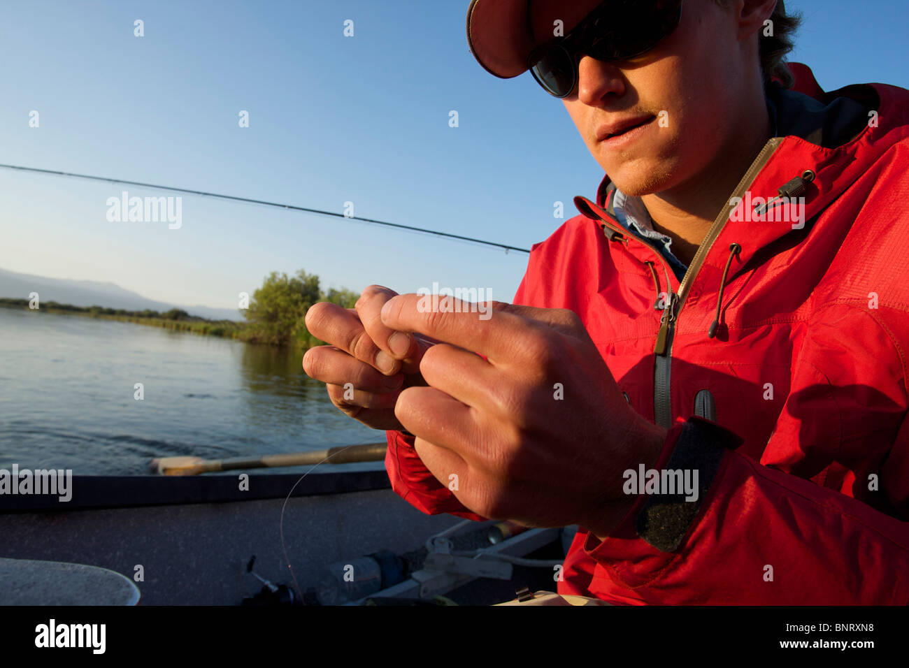 A man prepares to fish on the Teton River near Driggs, Idaho. Stock Photo
