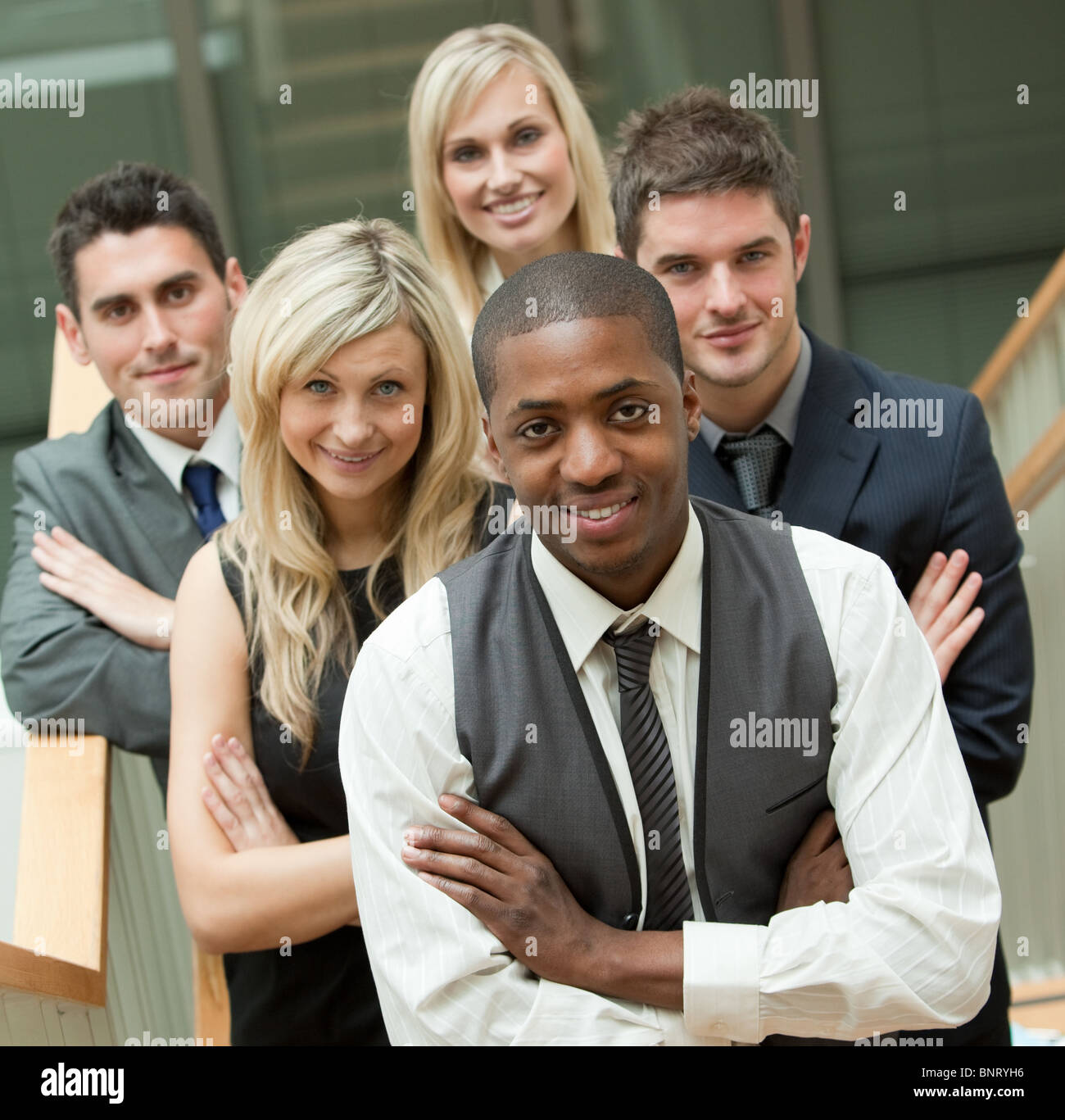 Happy business team looking at the camera Stock Photo - Alamy