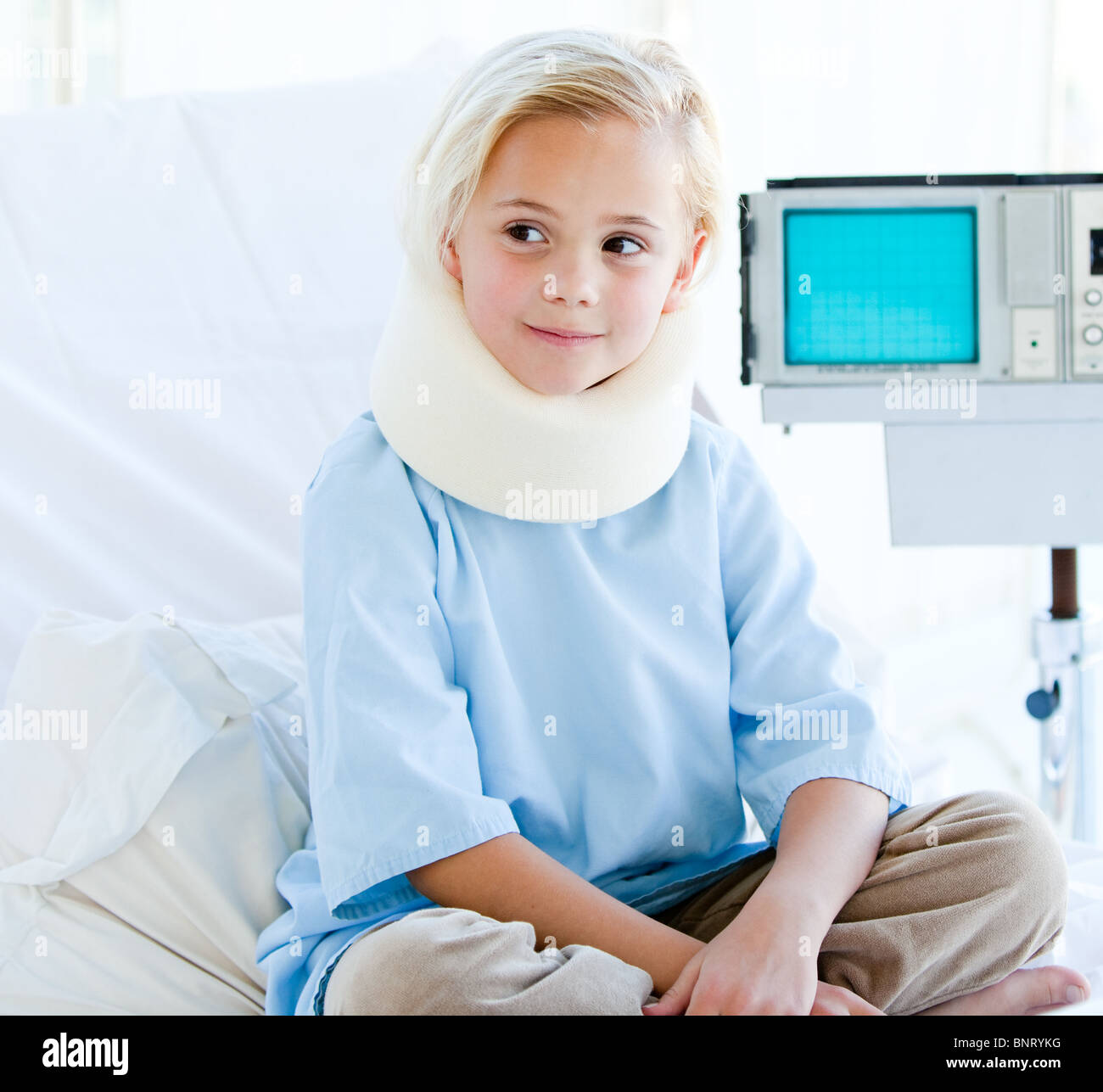 Little girl with a neck brace sitting on a hospital bed Stock Photo Alamy