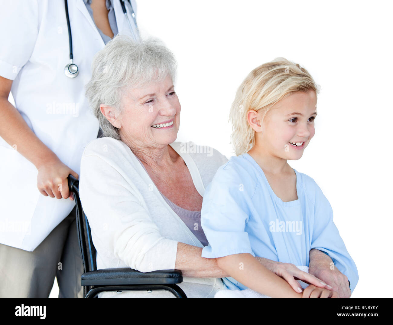 Smiling senior woman sitting on a wheelchair with her granddaughter in a hospital Stock Photo