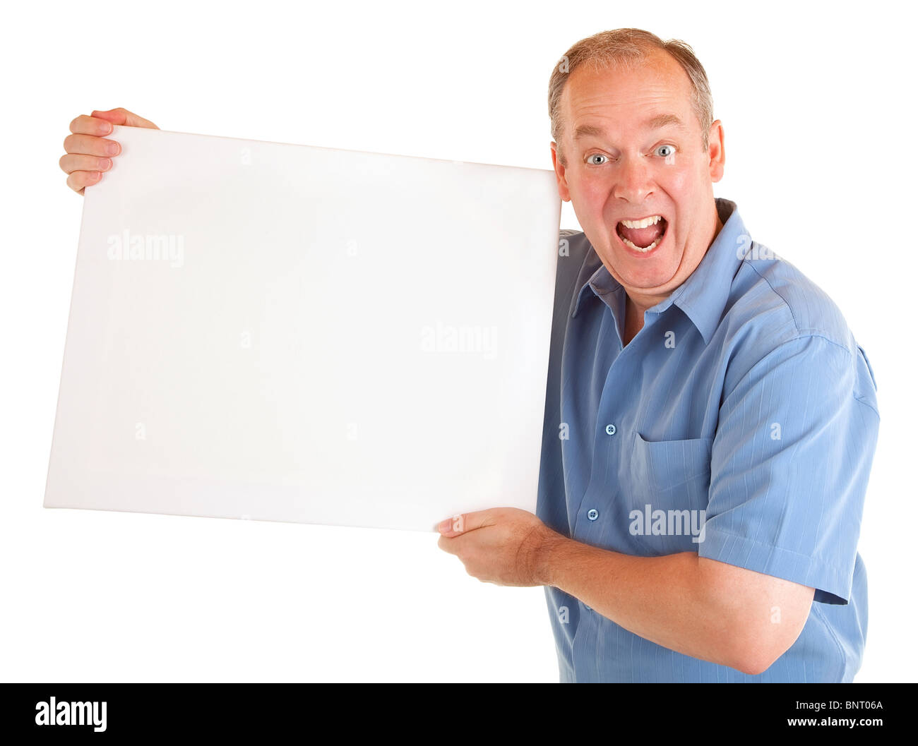 A man is holding and showing a blank white sign. Stock Photo