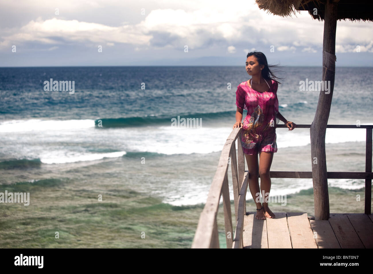 Young women in pink dress above tropical beach Stock Photo - Alamy