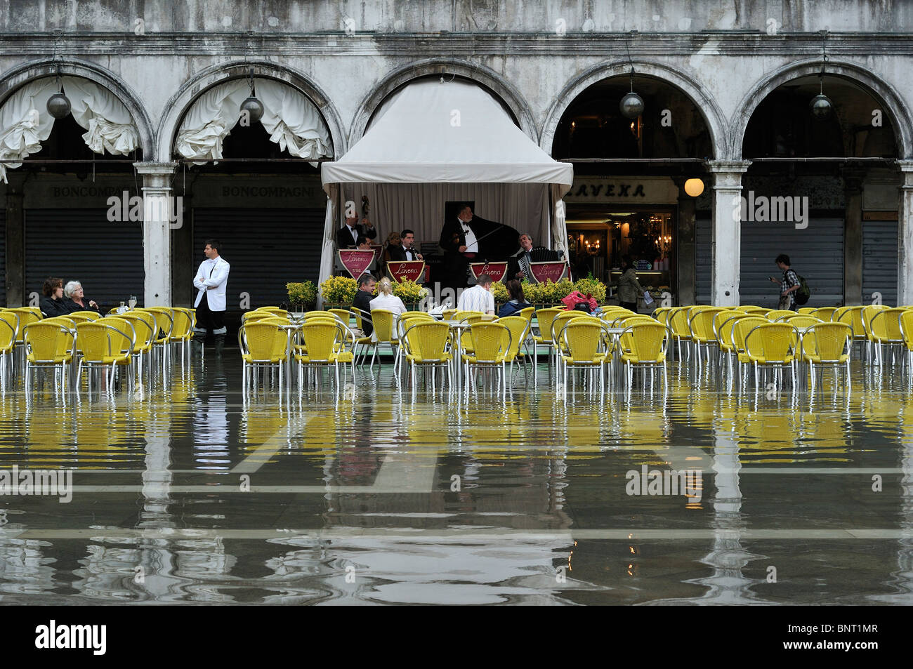 Venice. Italy. The orchestra plays as the tide comes in on St Mark's Square / Piazza San Marco. Stock Photo