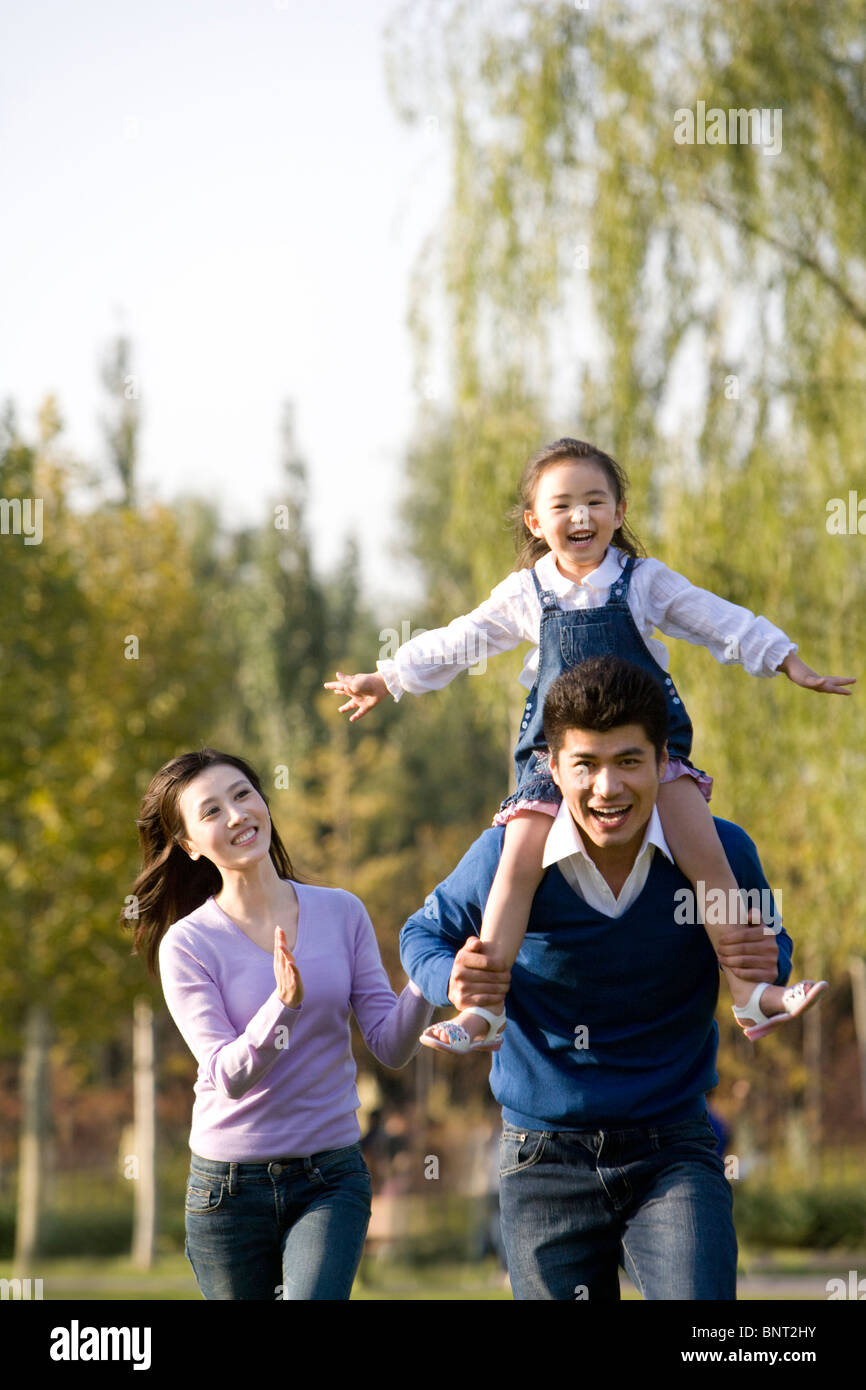 Young family playing in the park Stock Photo