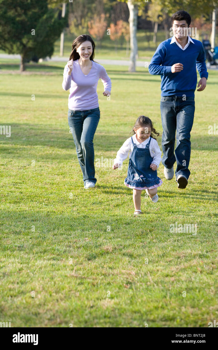 Young family playing in the park Stock Photo - Alamy