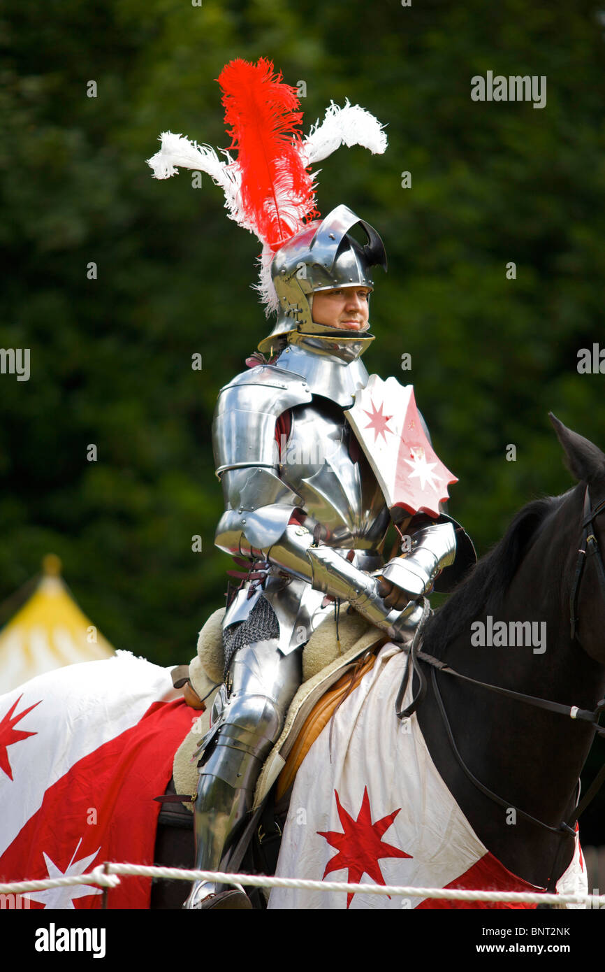 A re-enactor dressed in authentic armour as a mounted knight at a Medieval jousting tournament held at Arundel castle in Sussex Stock Photo