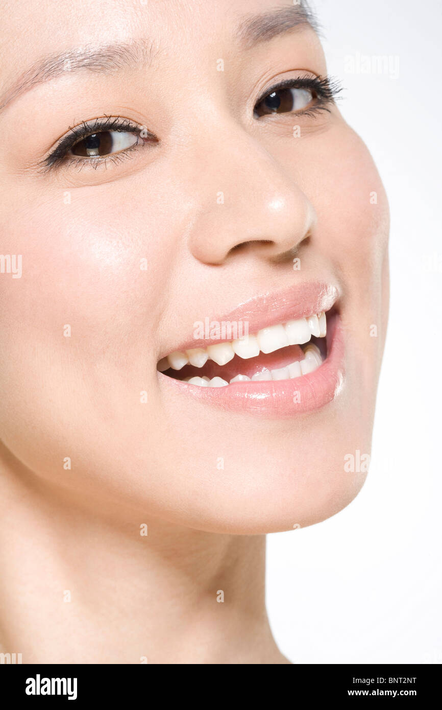 Face of young woman smiling Stock