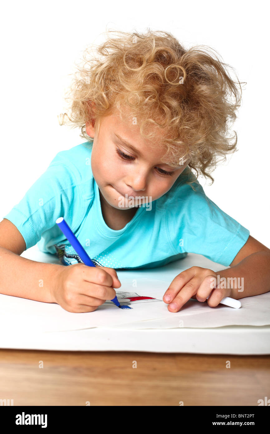 young boy drawing on big paper Stock Photo Alamy
