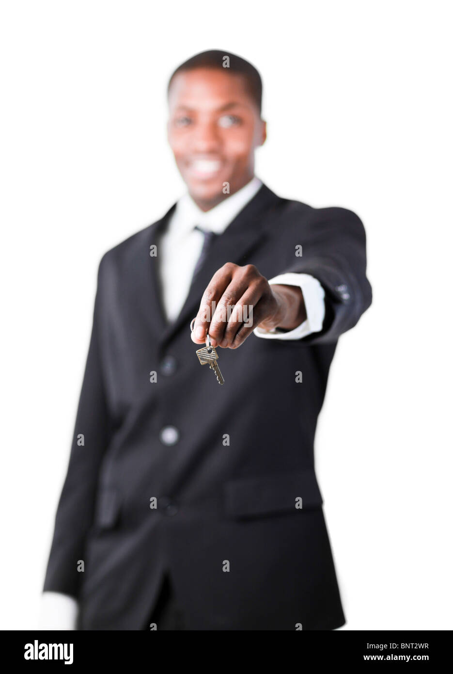 Young businessman holding a key Stock Photo - Alamy