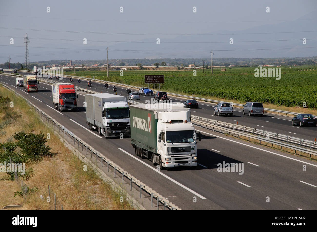 A9 autoroute carriageways seen north of Perpignan southern France Lorries using French motorway route Stock Photo