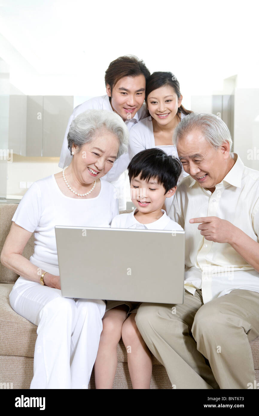 Multi generation family using a laptop Stock Photo - Alamy