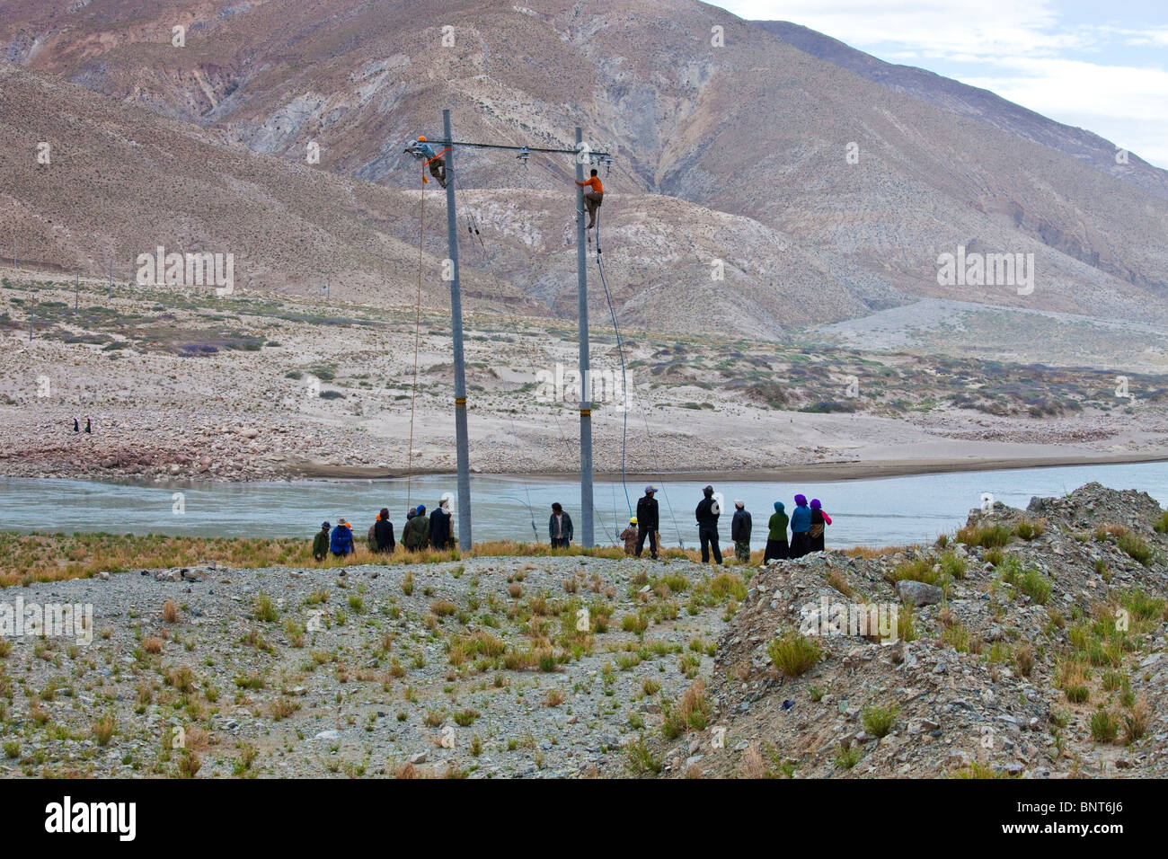 Utility poles going up in rural Tibet Stock Photo