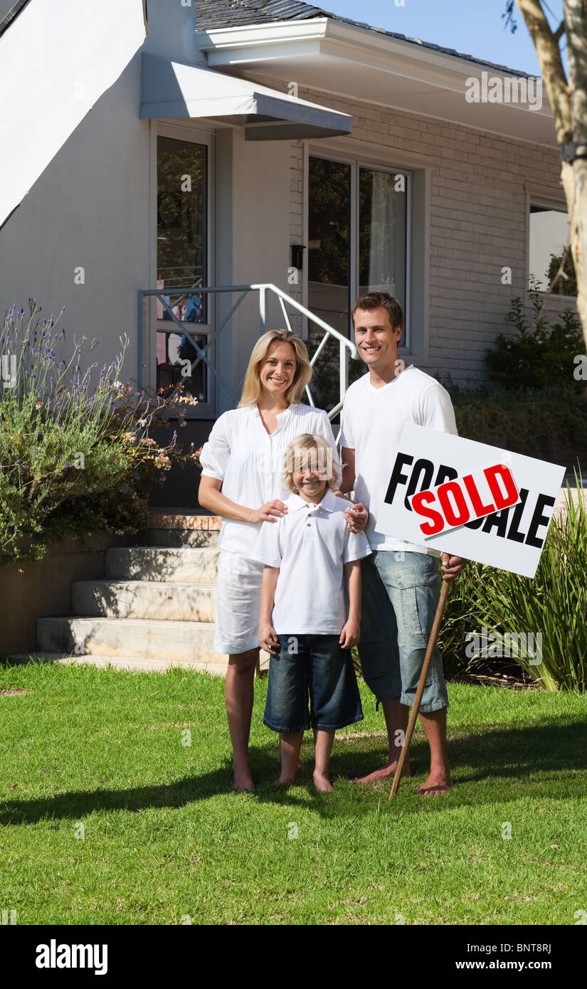 Happy family with their new home Stock Photo - Alamy