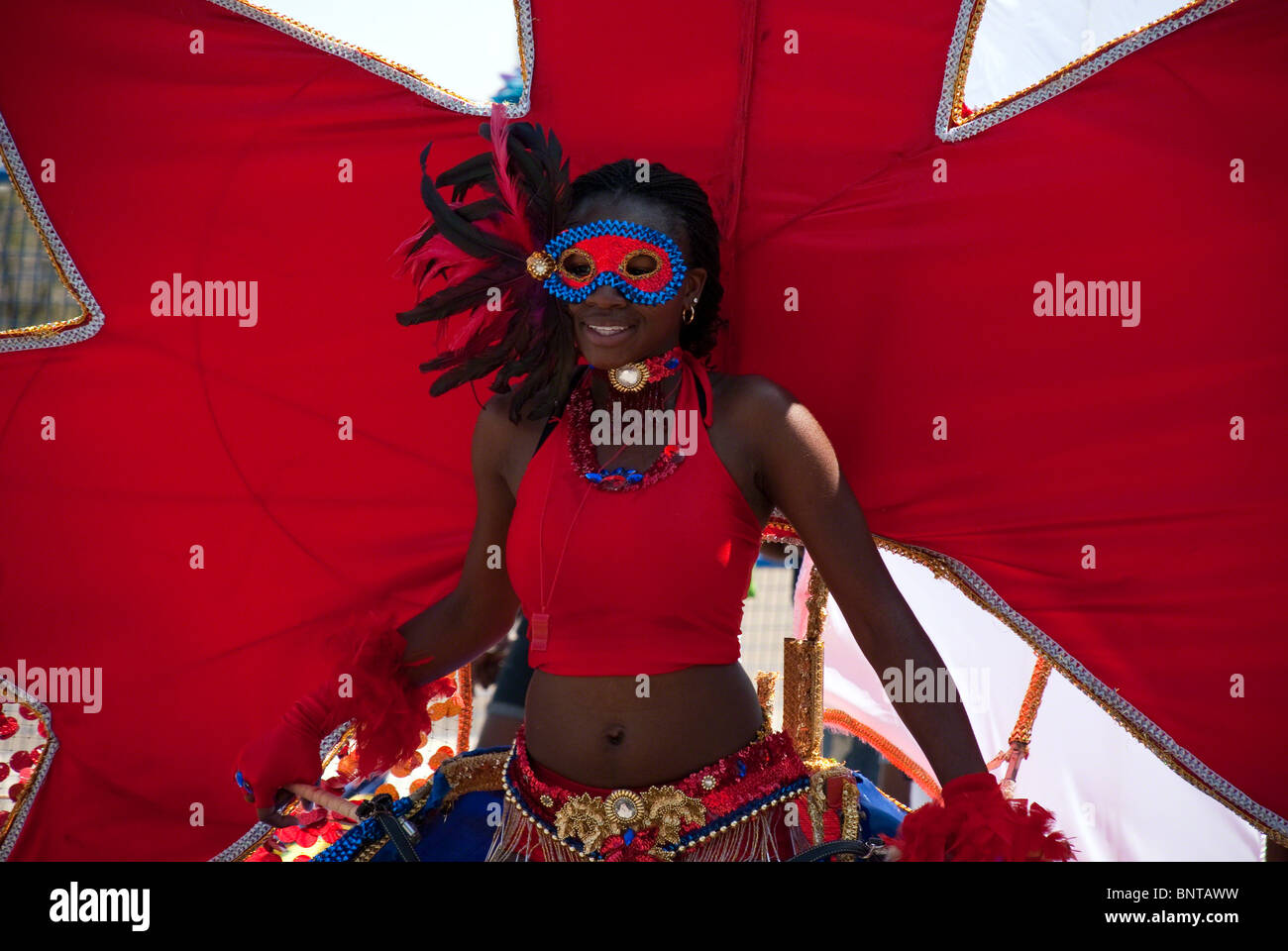 Beautiful female dancer in red - at the Toronto 2010 Caribana festival parade. Stock Photo