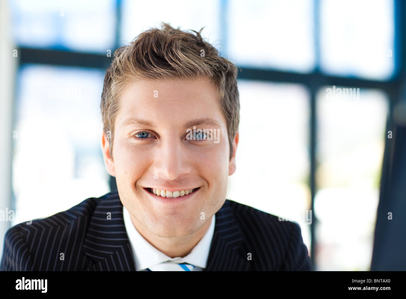 Attractive businessman smiling at the camera Stock Photo - Alamy